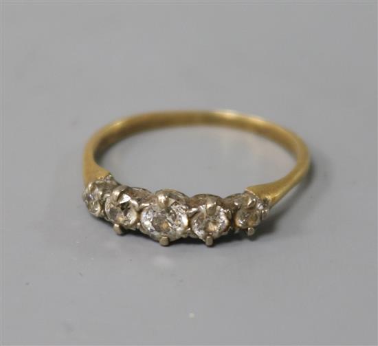 A yellow metal and graduated five stone diamond half hoop ring, size P.